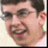 A pixelated close-up of a person with short dark hair and glasses, showing two sequential facial expressions with mouth movements.