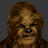 Pixelated close-up of a furry brown creature with dark eyes and nose, set against a solid gray background.