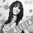 Pixelated grayscale image of a person with long dark hair and bangs, wearing a light-colored top with dark stripes, against a background with scattered gray shapes and partial text "AKO" in the upper right.