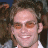 A pixelated image of a person with brown hair and orange-tinted glasses, next to green text reading 'Original Icons .com' on a dark background.