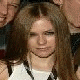 A static image of a person with long brown hair wearing a white sleeveless top, with yellow and white text and symbols overlaid on the image.