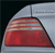 A pixelated red and white object resembling a car taillight with a curved top, set against a dark background with a light gray horizontal band above it.