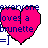 A pixelated heart-shaped icon with blue text reading "everyone loves a brunette" over a bright pink background.