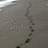 A pixelated grayscale image with a diagonal dark line and scattered light and dark pixels against a muted background.