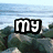 A pixelated beach scene with text overlays and a central figure in golden attire against rocky terrain.
