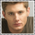 Static pixelated portrait of a person with light brown hair, neutral expression, and dark clothing against a muted background.