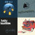 A static pixelated image divided into four quadrants showing abstract shapes and colors: blue and yellow forms in top-left, dark circular shape in top-right, white and black geometric shapes in bottom-left, and multicolored pixel clusters in bottom-right.