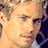 Static 48x48 pixel icon showing a close-up of a person's face with light skin tone, visible eyes, nose, mouth, and hair details in warm tones against dark background elements.