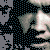 Pixelated static image showing partial face with light skin tone, dark hair, and dark clothing against gray background.