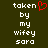 A dark green background displays two identical pixelated text blocks with white text reading 'taken by my wifey sara' and a red pixelated heart symbol above the right block.