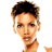 Pixelated static image of a person's face and upper torso with short dark hair, light skin tone, visible facial features including eyes, nose, mouth, and ear, wearing a white garment with brown accents on the shoulder area.