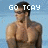 A pixelated image of a shirtless man with dark hair and sunglasses standing against a light blue background, with text overlays in the top-left, top-right, and bottom-left corners.