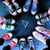 Pixelated image of multiple figures in motion against a dark blue background with scattered light effects.