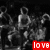 A grayscale pixelated image of a figure in motion with a red banner displaying 'love' at the bottom right.