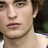 A pixelated close-up of a person's face showing light skin, brown hair, and a neutral expression with lips slightly parted.