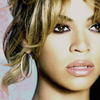 Close-up of a person with light brown hair styled in a side-swept manner, wearing large hoop earrings, against a light blue and pink patterned background.
