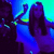 Animated sequence of a person with long dark hair in a white top under blue and green lighting, showing slight movement across frames.