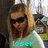 Pixelated image of a person with long brown hair wearing dark sunglasses and a light green shirt, with cyan text reading 'loser' at the bottom.