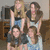 Four people pose in a group photo with one person raising their hand, and the word 'quads!' appears over the image.