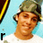 A person wearing a green cap and white shirt against a light blue background with yellow and black diagonal stripes, showing four distinct facial expressions.