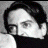 A pixelated grayscale image of a person with dark hair and a black top, next to large stylized text reading 'RESERVOIR DOGS' with red accents.