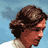 Pixelated static image of a person's head and shoulders against a blue background with white cloud-like shapes, rendered in low-resolution 256x256 pixels.