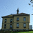 Pixelated image of a multi-story building with red text reading 'Takin' it Old Skool' against a light blue sky background.