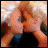 A 48x48 pixel animated buddy icon featuring a cartoon-style image of two people kissing, with text overlay explaining the context.