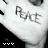 A black-and-white image of a person wearing a white shirt with the word "PEACE" written in dark, stylized letters across the chest.
