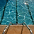 Pixelated image of a swimming pool with diving boards and text reading "South Swim Team..." on the right side.