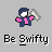 Pixelated character with dark blue hair and jacket, pink shirt, holding a silver object, standing above pixelated text reading 'Be Swifty' on gray background.