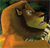 A pixelated close-up of a lion's face with golden-brown fur, green eyes, and a dark mane against a blurred green background.