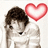 Pixelated figure with brown hair and white clothing, holding a large red heart symbol against a light background.