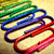 A static pixelated image shows overlapping paperclips in green, blue, purple, and red hues against a light beige background.