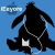 Pixelated black silhouette of a figure with outstretched arms against a blue background, wearing a chain necklace and holding a white rectangular object.