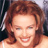 Static 48x48 pixel icon showing a close-up of a person with brown hair and light skin, smiling broadly with visible teeth against a dark background.