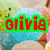 A pixelated image of a blue round character with a smiling face, green background, and red text reading 'olivia' in green outline.