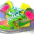 Pixelated image of a colorful cartoon character with green body, yellow accents, and pink circular elements on sides.