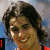 A four- shows a person with dark wavy hair smiling, with red text overlays changing