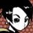 Pixelated white mask with black eye and mouth openings, held by a figure with brown hair against a black background.