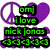 Pixelated icon with purple peace sign and heart, green text reading 'om] I love nick jonas <3<3<3', blue 'hottie<3' above a person's face.
