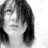 A grayscale animated sequence of a person with shoulder-length hair, showing text overlay changes and facial expression shifts across frames.