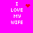 A bright pink background displays four identical text blocks reading "I LOVE MY WIFE" in white pixelated font, each with a distinct red animated symbol above the word "LOVE." The symbols include a solid heart, a starburst of dots, and two variations of scattered dot patterns.