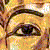 Pixelated close-up of a human eye with dark eyeliner, set against a warm-toned, blurred background of yellow and brown hues.