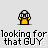 Pixelated character with black-and-white spotted cap and yellow body, repeated in pattern beneath text reading 'looking for that GUY' on light gray background