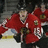 Pixelated image of hockey players in red jerseys with white accents on a blurred background, overlaid with text elements.