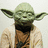 Pixelated green-skinned figure with large ears, dark beard, brown tunic, and light robe against plain background.