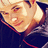 A pixelated image of a person with light hair wearing dark clothing, next to blue text reading "Emmett Cullen" and a small blue play button symbol.