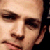A pixelated close-up of a person's face showing eyes, nose, and mouth with a neutral expression against a light background.