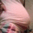 Pixelated static image of a light pink conical shape with darker brown and gray tones in the background.
